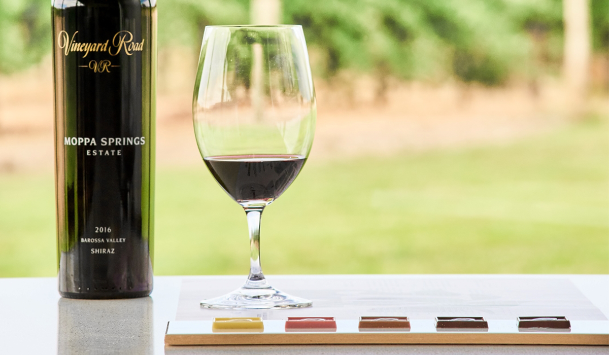 Vineyard Road wine bottle on table with glass